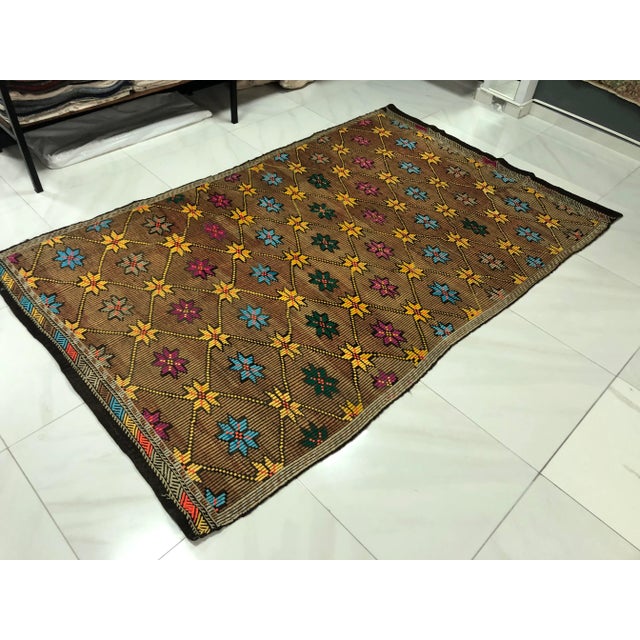 This is a vintage Turkish Anatolian kilim rug from the 1960s. The piece was hand-woven.