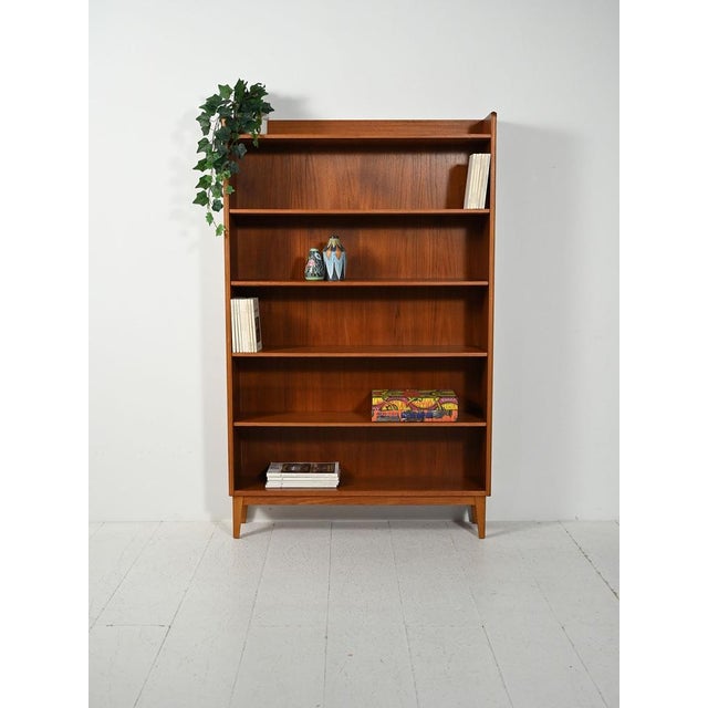 Scandinavian bookcase from the 1960s by Ferdinand Lundquist, made of teak with oak legs and adjustable shelves....