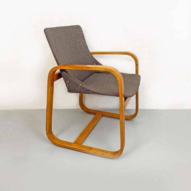 Italian Mid-Century Modern solid wood and grey fabric armchair, 1960s. Armchair with curved armrests in solid wood...