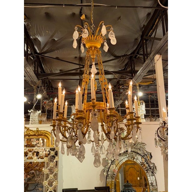 Fine 19th century French Louis XVI gilt bronze and rock crystal 16-light chandelier. Circa 1870. The chandelier has been...