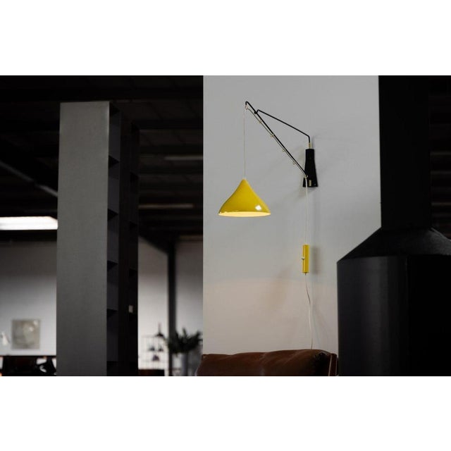 A remarkable fusion of engineering precision and sculptural design, this rare balance wall lamp was crafted by cosack...