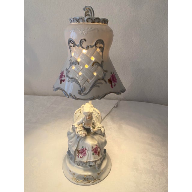 This is a Vintage Victorian French Style Porcelain Noble Woman holding basket of fruits figurine Boudoir table lamp. It...