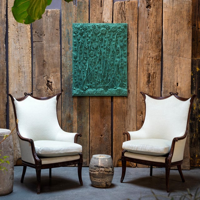 As if blotted with ink and brushed with calligraphy, this polished painting stone drum from Guangxi province is marked...