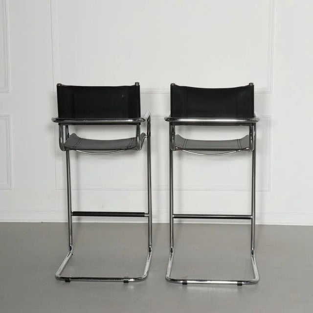 Pair of Italian chrome and black belt leather cantilevered bar stools in the style of Mart Stam. In wonderful vintage...