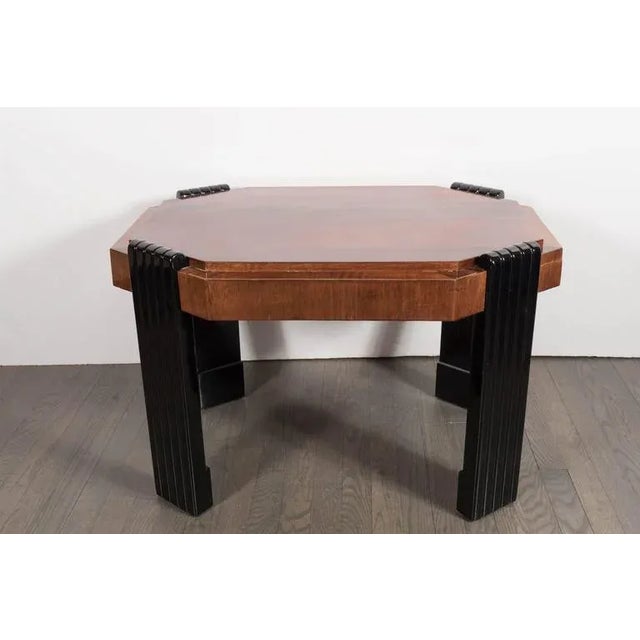 An Art Deco streamlined octagonal occasional table in burled walnut. Bookmatched detailing throughout, the top features a...
