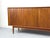A stunning mid-century sideboard from the Johannes Aasbjerg manufactory, crafted from teak. The body is finished in teak...