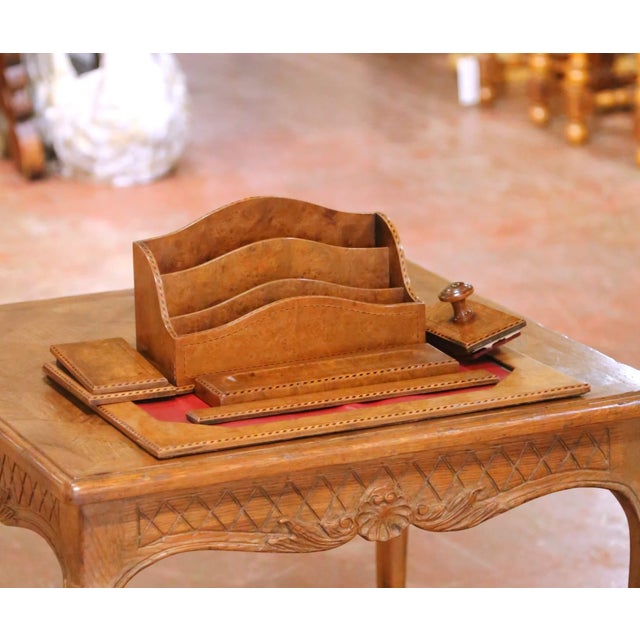 Elegant French desk set crafted circa 1950, executed in richly figured burl wood with a warm and luminous patina. The...
