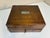 Wonderful antique wooden storage box dating to the early 20th century, featuring dovetailed construction, aged brass-tone...