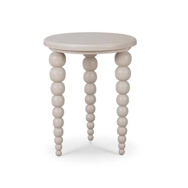 A unique piece that effortlessly combines contemporary design with playful elegance. This round side table features a...