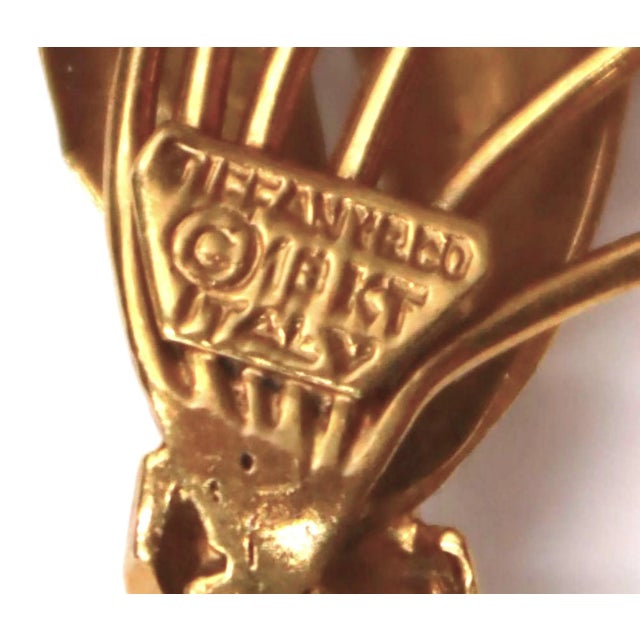 The Tiffany and Co. Yellow Gold Tulip Brooch is a beautiful and elegant piece of jewelry that is sure to be a treasured...