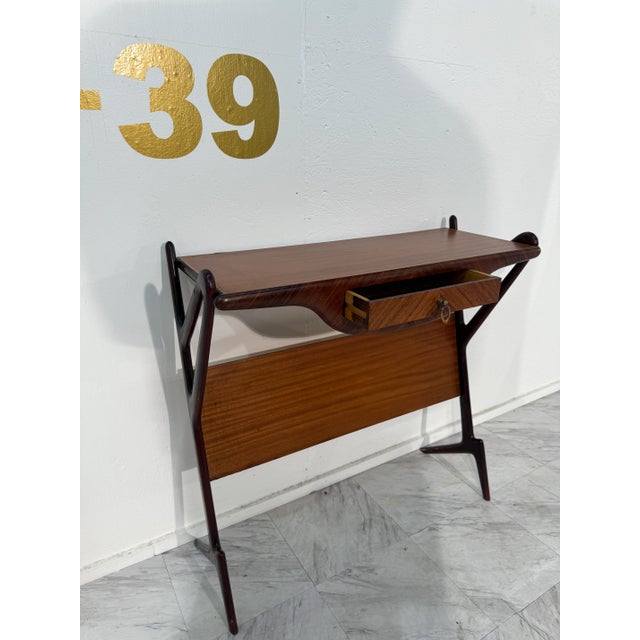 A refined mid-century Italian console, crafted in the 1950s, showcasing the era’s elegant craftsmanship and functional...