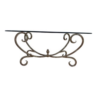 Vintage Hollywood Regency Style Coffee Table Featuring a Gold-Finished Wrought Iron Base With Scrollwork and an Oval Beveled Glass Top For Sale