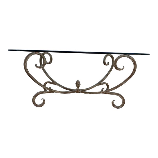 Vintage Hollywood Regency Style Coffee Table Featuring a Gold-Finished Wrought Iron Base With Scrollwork and an Oval Beveled Glass Top For Sale