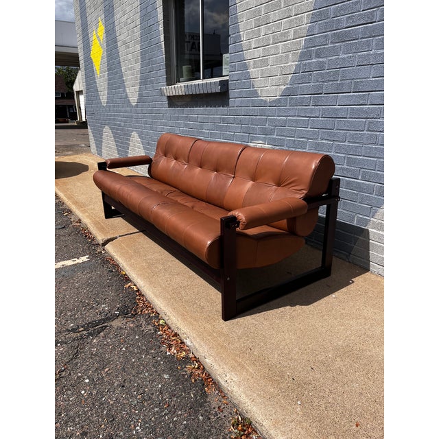 Exceptional Mid-Century Modern Brazilian sofa by Percival Lafer, featuring a beautifully crafted Brazilian rosewood frame...