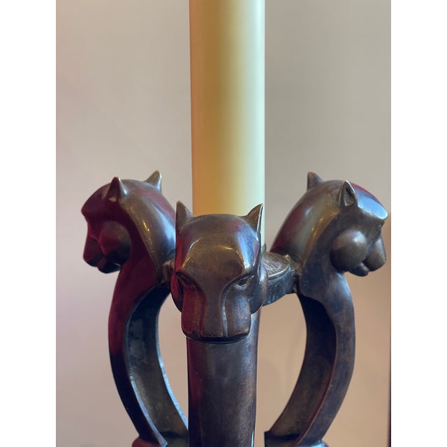 The Patinated Bronze Panther Table Lamp exudes an air of regal elegance with its striking design. Three majestic panther...
