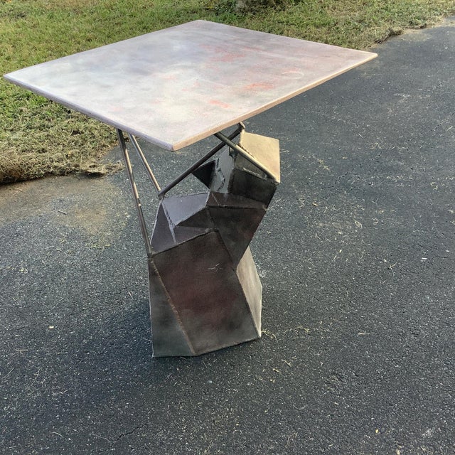 Wonderful Mixed media table, Steel base supports welded iron rods to the bottom of the stone table top. Very contemporary...
