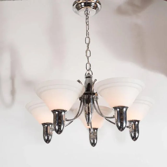 This wonderful chandelier is made of polished chrome and fitted with five uplight with hand blown crème glass shades with...