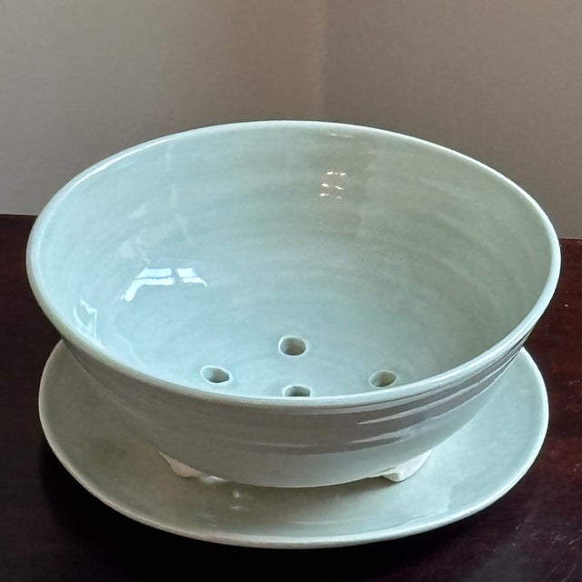 A beautifully handcrafted studio pottery berry bowl / colander with original matching underplate and finished in a serene...