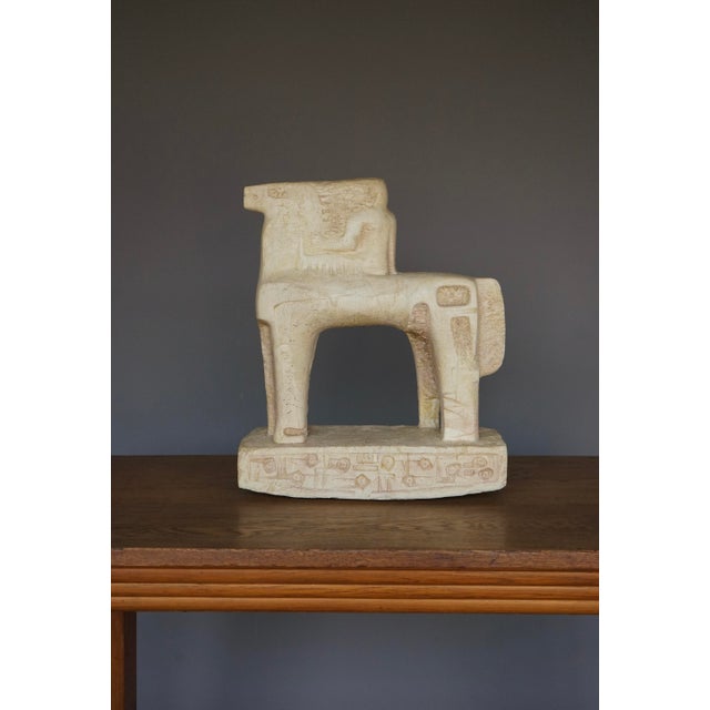 A large sculpture of a horse and rider - Made from what appears to be cast and then carved stone. Made in the 1970s, it...