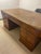 True partners desk will comfortably fit 2 people. Storage is the same on both sides. 1 drawer with an open space below on...