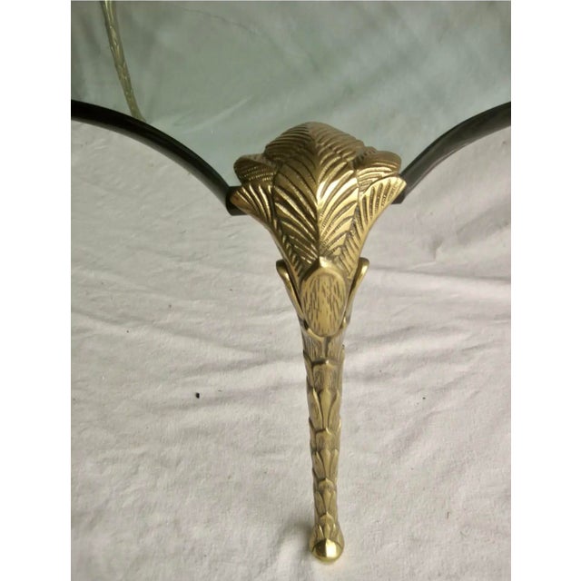 Maison Bagues Bronze and Glass Cocktail Table. The rectangular beveled glass top raised on leaf and frond cast cabriole...