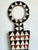 This striking vintage tribal geometric painted wood shield is a powerful example of functional art transformed into...