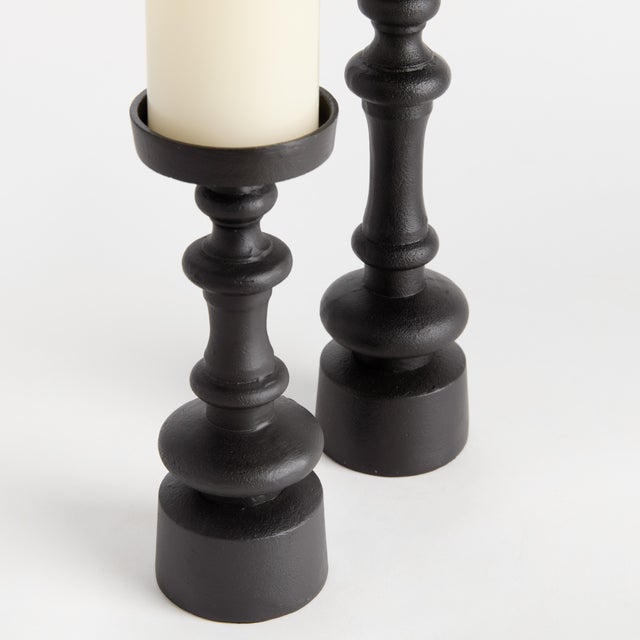 In a chunky, classic silhouette, the notches along the body of these candle stands add a modern touch. This set of two...