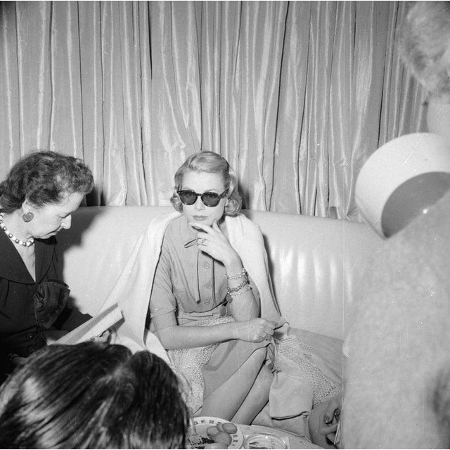Interviewing Grace May 1956: American actress Grace Kelly (1929 - 1982) being interviewed by journalists aboard the...