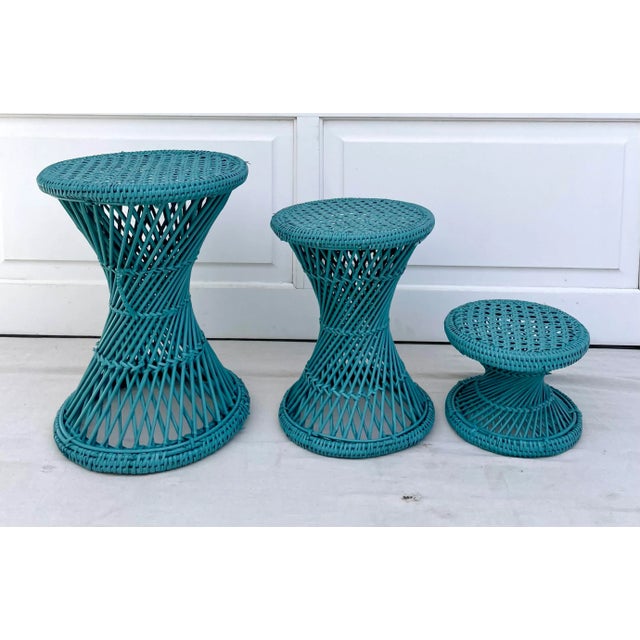 Here is a charming set of three wicker and cane stools that are painted in a fantastic teal blue. Each stool shares a...