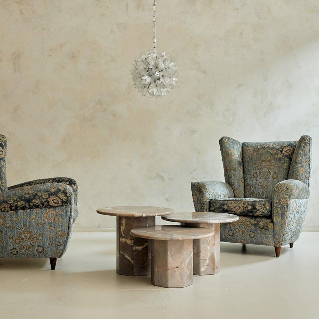 An Italian lounge chair from the 1950s, defined by its enveloping wingback silhouette and generous proportions. The frame...