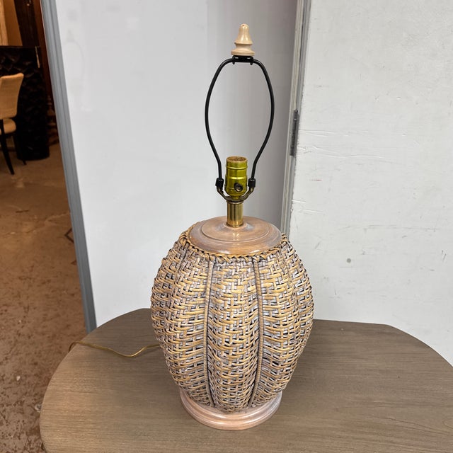 Design Plus Gallery presents a Coastal Woven Rattan Table Lamp. This table lamp has a rounded gourd form base with an open...