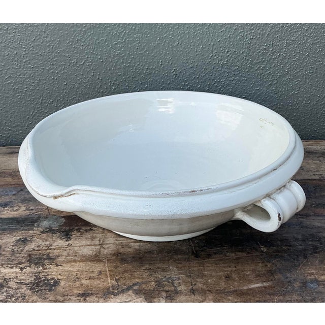 Exude the quiet charm of a European farmhouse with this impressive vintage ceramic bowl. Crafted with a thick, substantial...