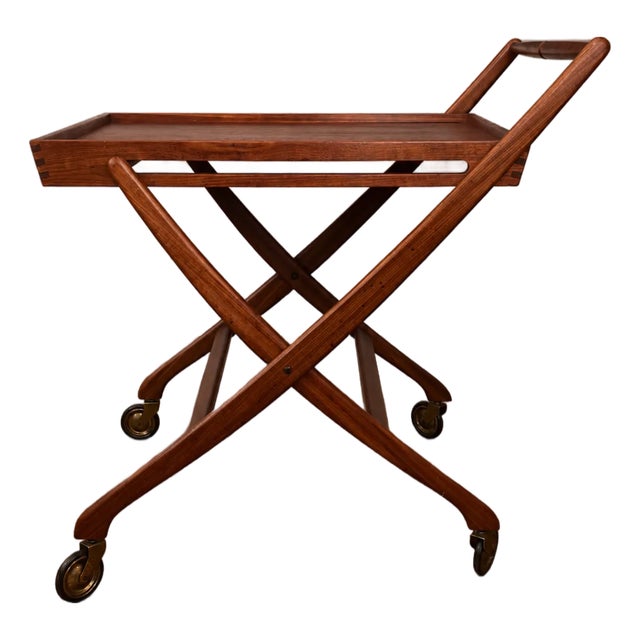 Beautiful vintage mid-century moderntt folding tea, serving, or bar cart, crafted in richly grained teak with an elegant...