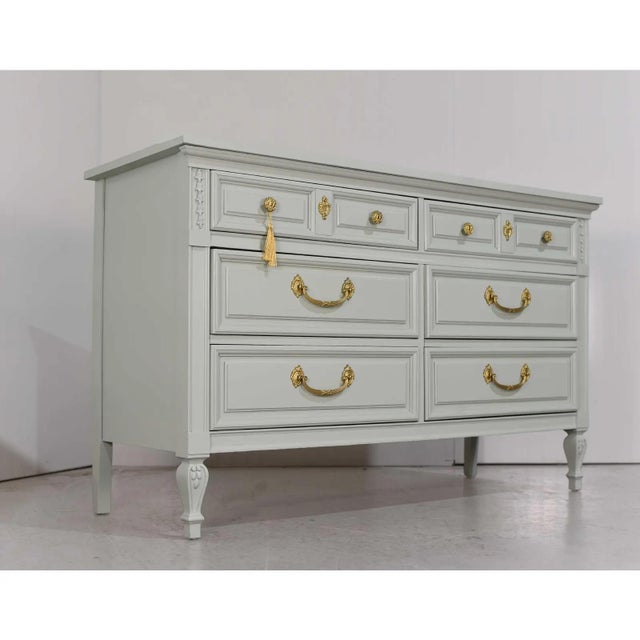 We have a gorgeous Mid Century French Louis Style Dresser by Dixie, newly painted to add a fresh, modern twist to its...