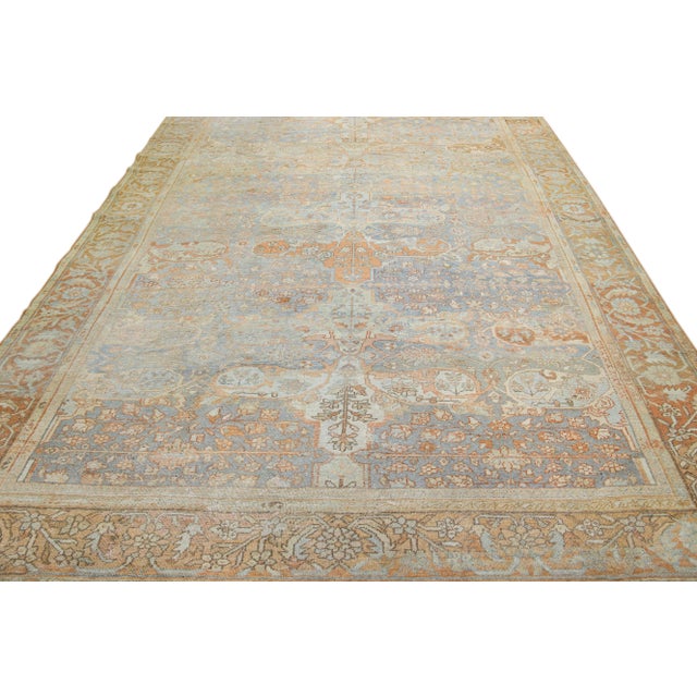 Beautiful antique Persian Sultanabad hand-knotted wool rug with a light blue field. This piece has a rusted designed frame...