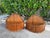 Distinctive vintage pair of sculptural wall baskets crafted from slender split bamboo slats, hand-bound with natural fiber...