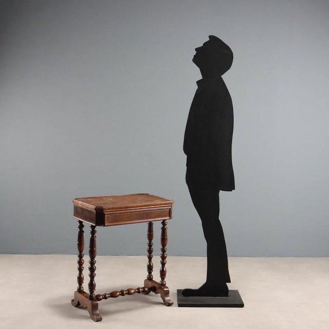 Walnut work table. Drawer in the lower section, turned legs joined by a turned crosspiece, resting on curved feet. Poplar...