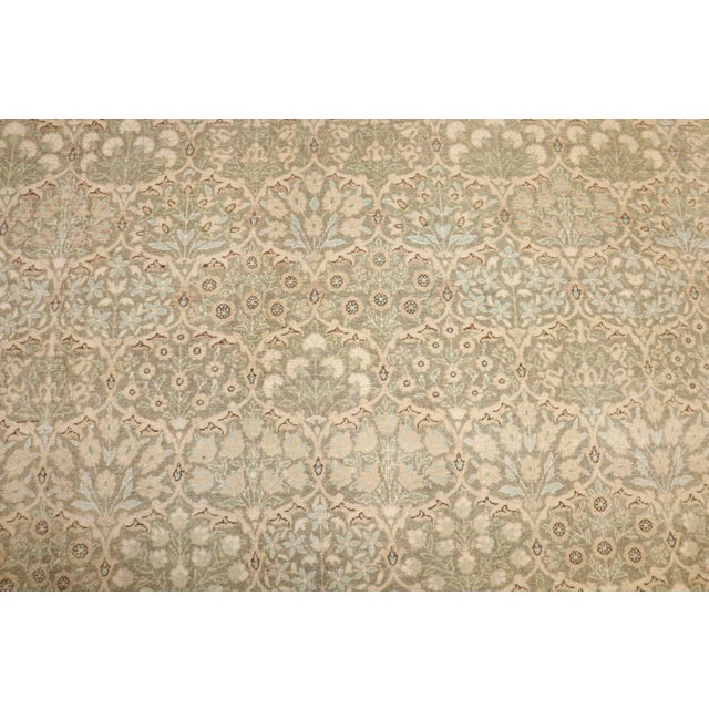 A mid 20th century Persian Tabriz floral pattern rug in neutral tones Measures: 7'10'' x 11'3''.
