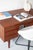 A handsome Danish executive desk in teak, standing on classically mid century rocket style legs. The desk has six deep...