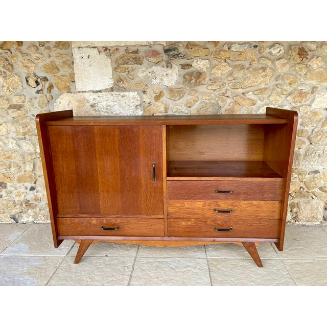 Mid-century, vintage oak buffet/storage unit, circa 1950's. the piece is made of oak, with a golden-oak colored veneered...