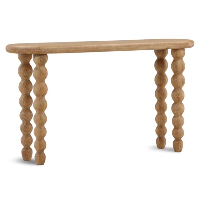 Solid mango wood sculptural console table which will bring warmth, texture, and organic character to any interior. Four...