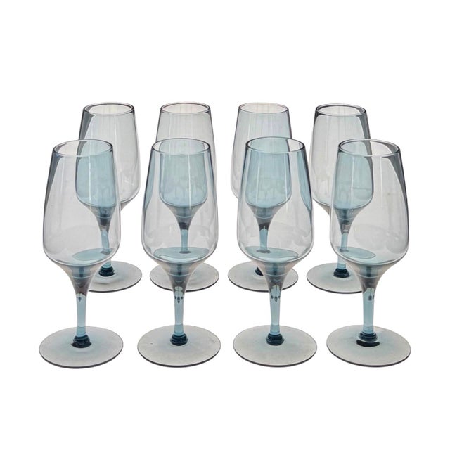 A chic set of eight 1960s crystal goblets in a color that can only be described as “smokey sapphire”. Light catches hints...
