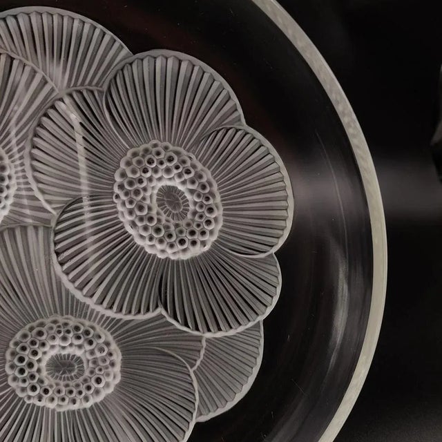 A Large bowl by Verlys with three poppy flowers in frosted glass.