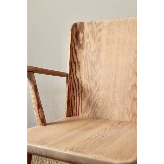 A beautiful early Swedish pine armchair designed by Göran Malmvall, circa 1940s–1950s. The chair is crafted from solid...