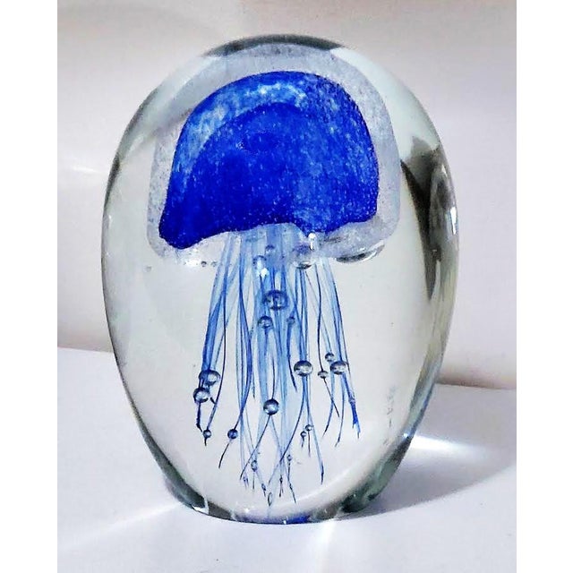 Hand blown cobalt blue glass jellyfish paperweight. Crafted from lead free glass featuring internal bubbles to create a...