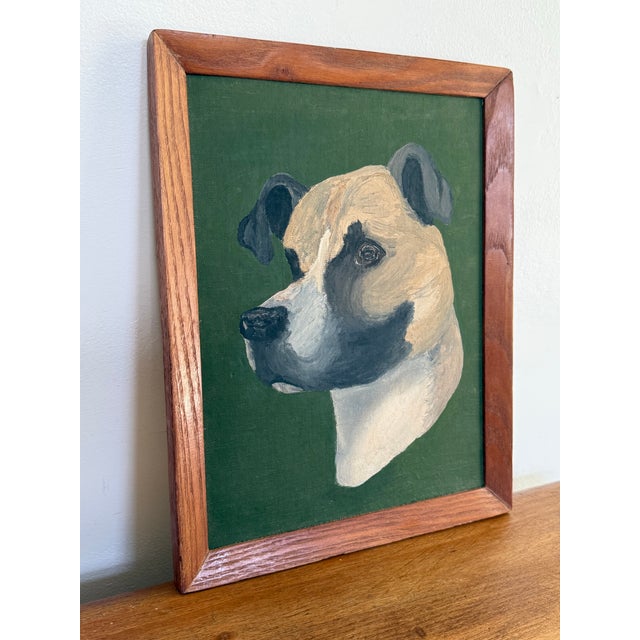 Folk Art oil painting of a dapper dog on a rich green backdrop. Framed beautifully and simply in wood. Unsigned by the...