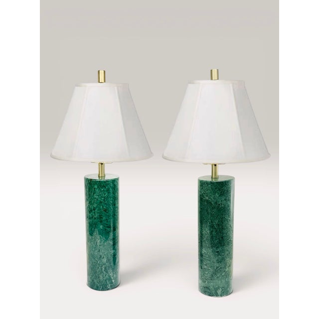 A striking pair of substantial verde solid-marble column lamps featuring rich emerald veining and warm satin brass...