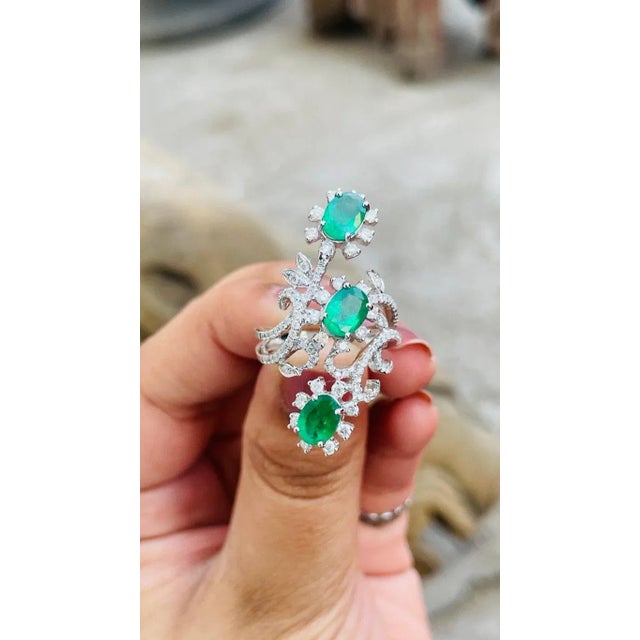 This is part of Chairish’s Fine Jewelry assortment. Emerald and diamond three stone cocktail ring in 14K gold which...