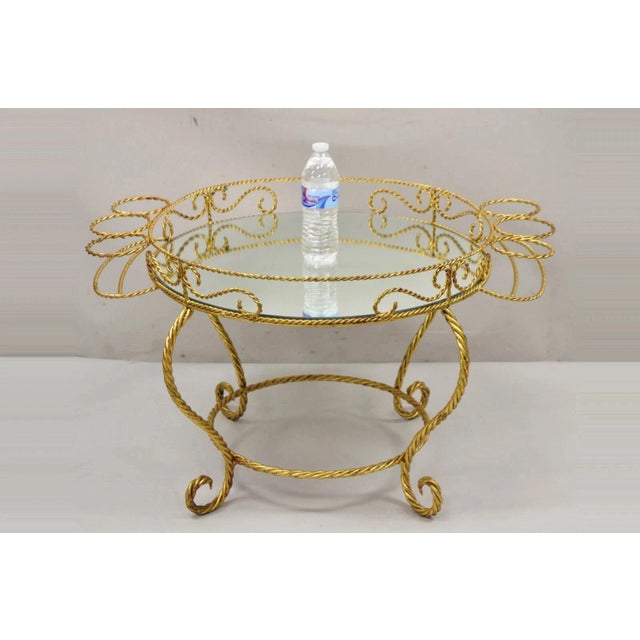Vintage Italian Hollywood Regency Iron Gold Rope Bar Coffee Table with Round Mirror Top. Item features a scrolling iron...
