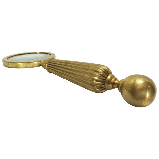 We are offering a brass letter opener and magnifying glass. This selection includes a brass magnifying glass and letter...